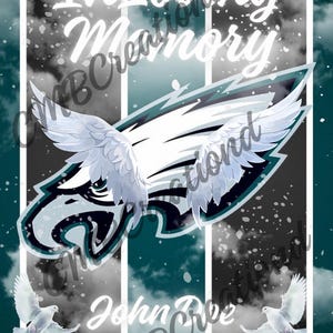 May include: A memorial design featuring the text "In Loving Memory" in white script above an eagle emblem with outstretched wings. The design includes the name "John Doe" and dates September 7, 1936 - November 25, 2025, with dove illustrations.