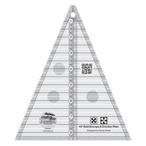 May include: A clear, triangular quilting ruler with black markings and a series of horizontal and diagonal lines. The ruler has a hole at the top and includes the text "45" Kaleidoscope & Dresden Plate". The ruler is designed by Penny Haren.