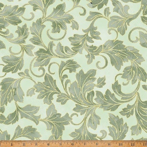 May include: A light mint green fabric featuring a repeating pattern of sage green acanthus leaves outlined in metallic gold thread. A wooden ruler is visible at the bottom edge, showing measurements in inches from one to twelve.