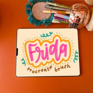 May include: A digital drawing of the word "Frida" in pink, orange, and green on a cream background. The text "procreate brush" is written below the word "Frida".