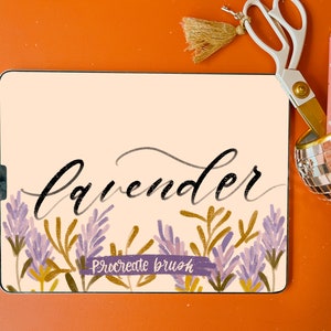 May include: A digital art piece with the word "lavender" in elegant script, accompanied by lavender and gold botanical illustrations. The image includes scissors, a pen, and a disco ball-style pen holder, all set against an orange background.