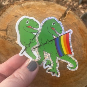 Dinosaur with Pride Flag, White Matte or Glitter Vinyl, waterproof sticker