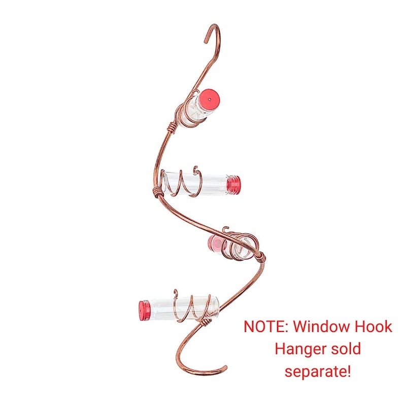 May include: Copper-colored hummingbird feeder with three clear glass tubes and red caps. The feeder has a curved, spiral design with a hook at the top for hanging. The text on the image says "NOTE: Window Hook Hanger sold separate!"