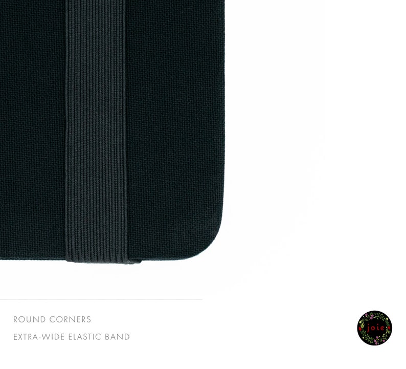 May include: Close-up of a black notebook with rounded corners and an extra-wide elastic band.