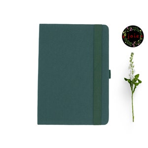 May include: A dark green hardback journal with a matching elastic closure and a ribbon bookmark. The journal has a simple, elegant design.