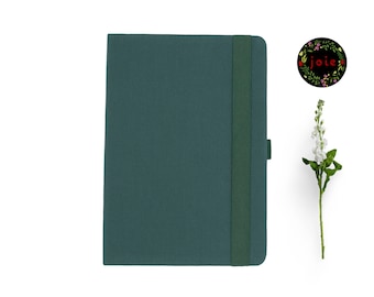 May include: A dark green hardcover journal with a matching elastic closure and a bookmark ribbon. The journal has a simple, elegant design.