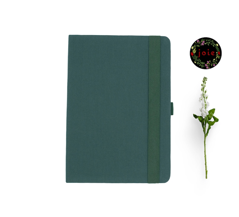 May include: A dark green hardback journal with a matching elastic closure and a ribbon bookmark. The journal has a simple, elegant design.