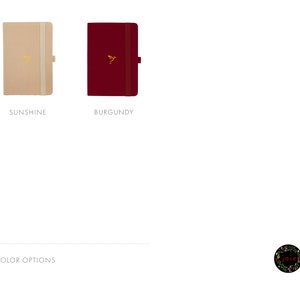 May include: Two closed notebooks, one in a beige color and the other in a burgundy color. Both notebooks have a gold hummingbird logo on the front cover. The text "SUNSHINE" is below the beige notebook and the text "BURGUNDY" is below the burgundy notebook. The text "COLOR OPTIONS" is at the bottom left of the image. A small logo with the text "joie" is at the bottom right of the image.