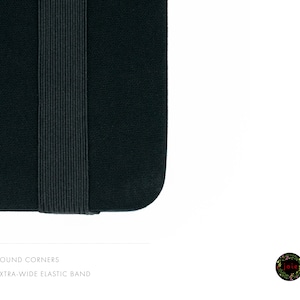 May include: Close-up of a black notebook with rounded corners and an extra-wide elastic band.