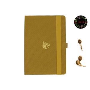May include: A mustard yellow notebook with a gold cactus design and a yellow elastic closure. The notebook has a textured cover and a blank page.