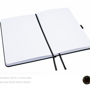 May include: A black notebook with a dotted grid and a black ribbon bookmark. The notebook has 176 pages with 0.5 mm grid and 160 gsm extra white pages.