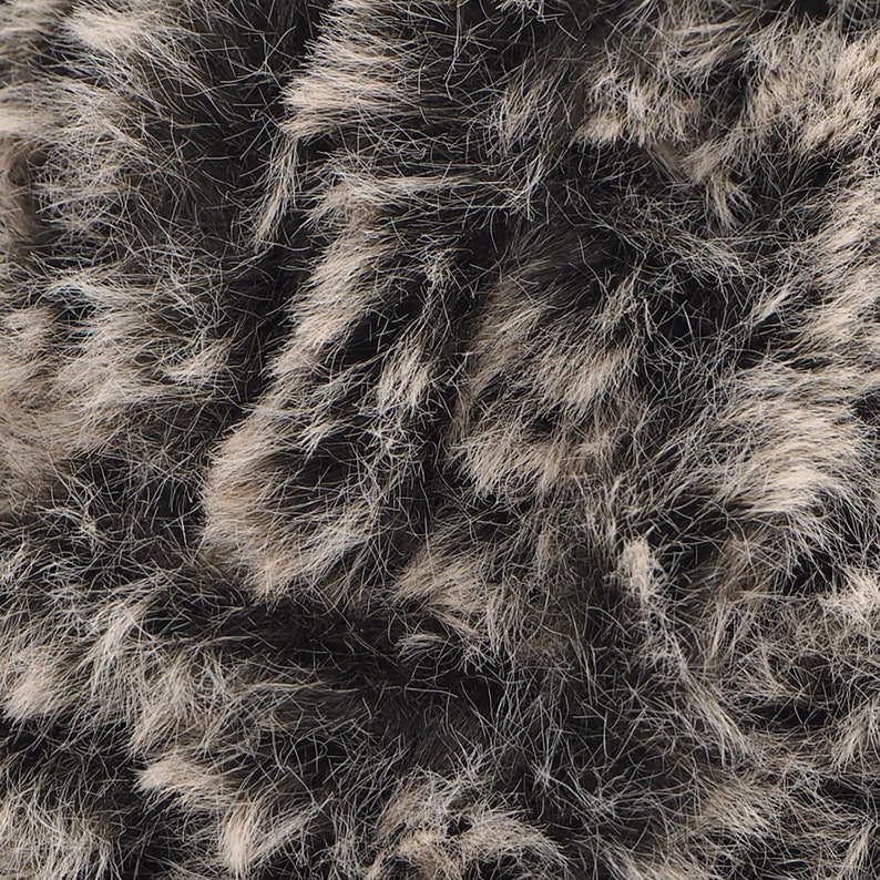 May include: Close-up of a soft, fluffy, gray and white fur texture.