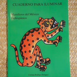 May include: A green coloring book titled "CUADERNO PARA ILUMINAR" with the text "Mamíferos del México Prehispánico." The cover features an orange jaguar illustration with black spots. The author's name, Corinna Rodrigo Enriquez, is at the bottom.