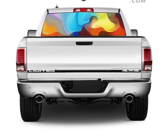 May include: A white pickup truck with a black "LIMITED" and "4x4" emblem on the tailgate. The rear window has a colorful abstract graphic decal.