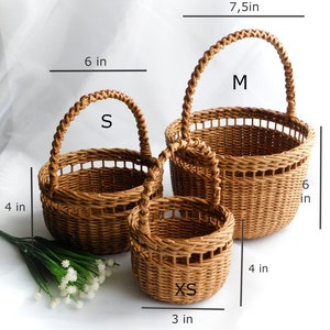 Set of three round baskets in brown color. Baskets are made using weaving technique in three different sizes. Baskets can be used as wedding baskets for flower girls of different ages from 2-12 years old.