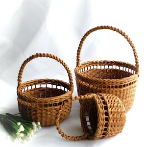 A set of wicker rustic wedding baskets for flower girls of different ages.