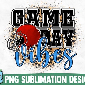 May include: A sublimation design featuring a football helmet, leopard print, and the text "Game Day Vibes" in blue and black lettering.