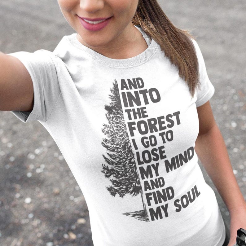 May include: White t-shirt with a black and gray graphic of a tree and the text "And into the forest I go to lose my mind and find my soul."
