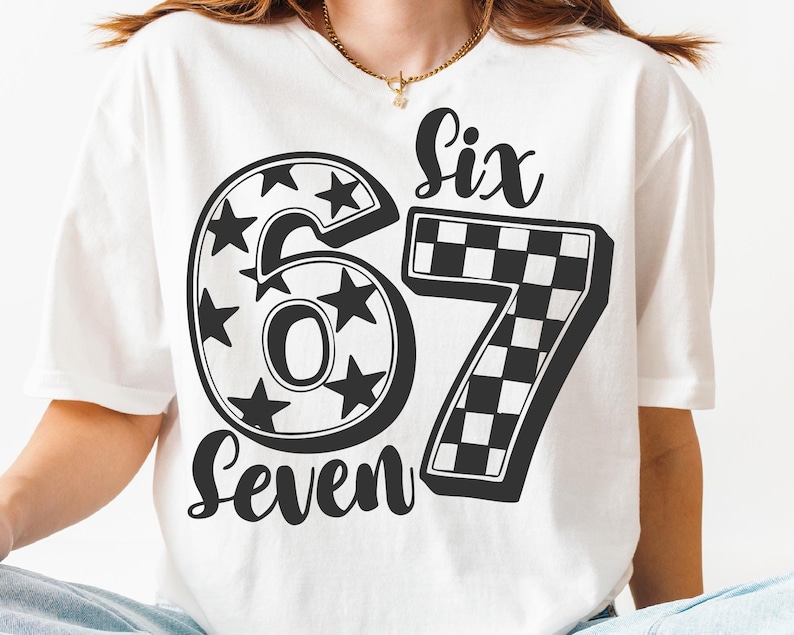 May include: White t-shirt with a black design of the numbers "67". The number "6" is decorated with stars, and the number "7" has a chequered pattern. The words "Six" and "Seven" are written above and below the numbers.