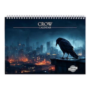 May include: A spiral-bound calendar featuring a dark illustration of a crow perched on a rooftop overlooking a city skyline at night. The calendar is titled "CROW CALENDAR" in white text.