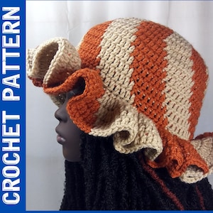 May include: A crocheted hat with a wide brim and a ruffled edge. The hat is striped in orange and beige.