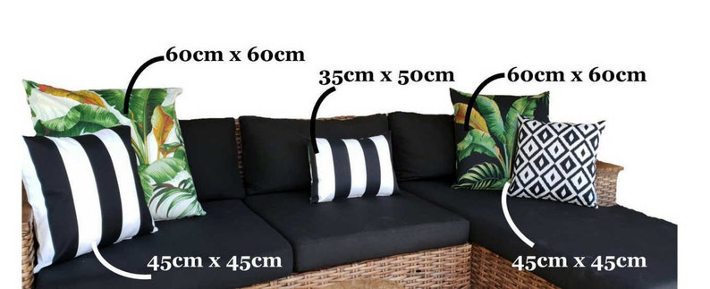May include: A black wicker sectional sofa with five black and white striped throw pillows, two black and white geometric throw pillows, and two tropical leaf print throw pillows. The pillows are labelled with their dimensions in centimetres.