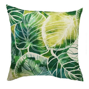 May include: Green and white throw pillow with a leafy pattern. The pillow is made of a soft, textured fabric.