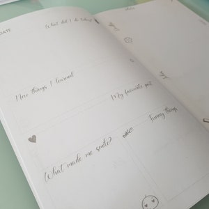 May include: A blank journal page with prompts for daily reflection. The prompts include "What did I do today?", "New things I learned", "My favorite part", "What made me smile?", "Funny things", and "OMG!!!".