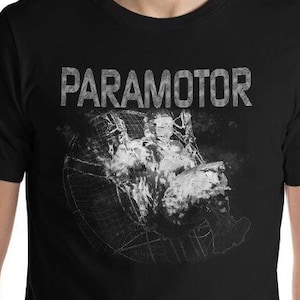 May include: A white ceramic mug with a black handle and the text "But First, Coffee" in a black, handwritten-style font. The mug is on a white surface.