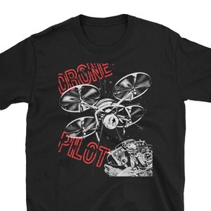 May include: Black t-shirt with a white graphic of a drone with the text "DRONE PILOT" in red.