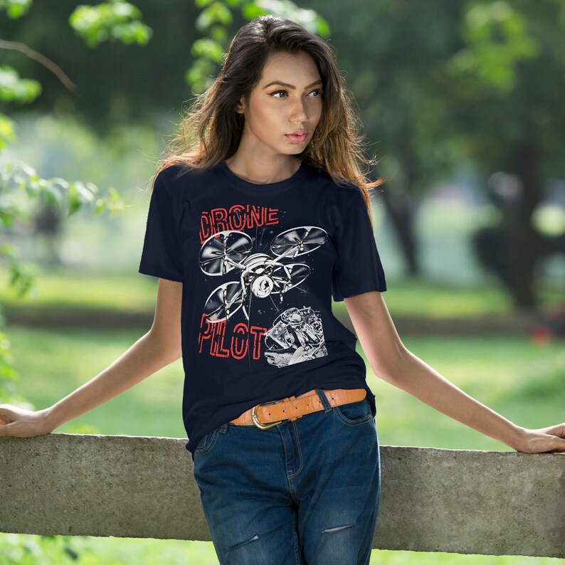 May include: A navy blue t-shirt with a white graphic of a drone and the text "Drone Pilot" in red.