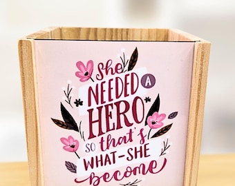 Pink background with small reading  - personalised pen pot - crafted from spruce pine - a stylish desk touch - vibrant colours