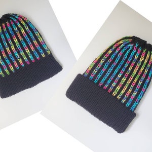 May include: A black knit beanie with vertical stripes in vibrant rainbow colors. The hat features a folded brim and a ribbed texture, offering a stylish and colorful accessory for cold weather.