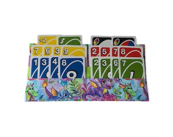 May include: A fabric wallet with a colorful dragon print. The wallet is open and has several cards inside, including a +2, 7, 6, 3, 9, 2, 5, 7, 8, 3, 6, and 7 card.