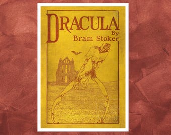 May include: A rectangular print featuring a yellow background with the text Dracula By Bram Stoker in dark red. The illustration depicts a tall, thin, skeletal figure standing in a field near a stone ruin with a small bat flying in the sky.