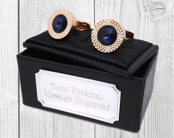 May include: A pair of gold cufflinks with blue gemstones in a black gift box. The box has a silver plaque with the text "Your Personal Message Engraved".