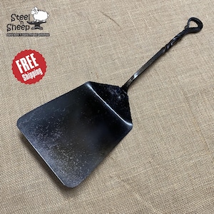 May include: A black metal pizza peel with a twisted handle and a heart-shaped end. The peel is on a brown burlap background. FREE Shipping.