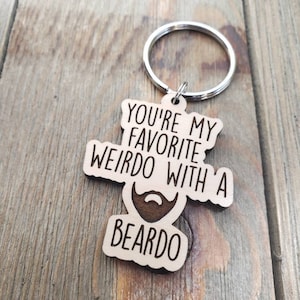 May include: Wooden keychain with the text "You're my favourite weirdo with a beardo".