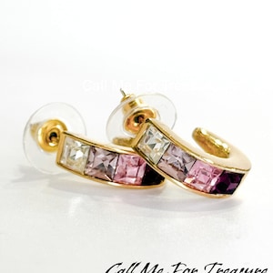 May include: Gold hoop earrings with a gradient of pink, white, and clear square-shaped crystals.