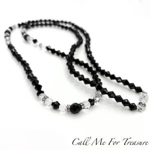 May include: A black beaded necklace with clear crystal accents and a silver clasp. The necklace features a mix of faceted and round beads, creating a sparkling effect. The text "Call Me For Treasure" is at the bottom.