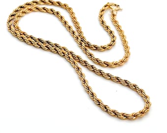 May include: A gold-toned rope chain necklace featuring a twisted metal link design with a circular spring ring clasp. The necklace is arranged in a loose, overlapping loop formation. The text "Call Me For Treasure" is visible in the bottom right.