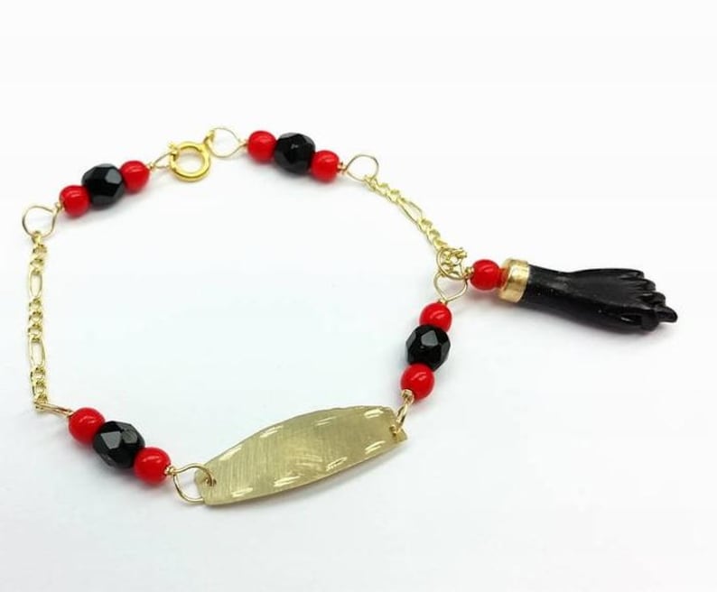 NEW 10K GOLD AZABACHE BABY BRACELET (PROTECTION FROM EVIL EYE) Pulsera Azabache. pulsera azabache de oro 
PULSERA MANO DE AZABACHE BEBE DE ORO (MAL DE OJO). 10K Solid Gold Azabache Bracelet for newborn babies 
Also called "Mano de Azabache"