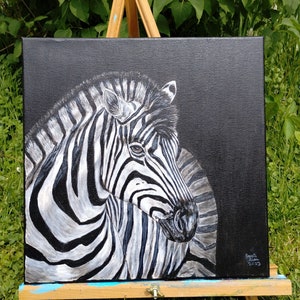 May include: A black and white zebra painting on a black canvas. The zebra is facing the right side of the painting and has its head turned to the left. The zebra's stripes are painted in a realistic style. The painting is signed and dated in the bottom right corner.