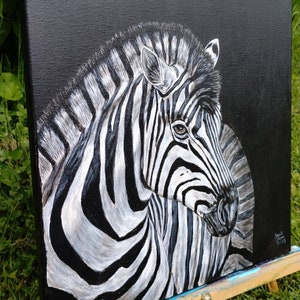 May include: A black and white zebra painting on a black canvas. The zebra's head is turned to the side, and its stripes are visible in detail.