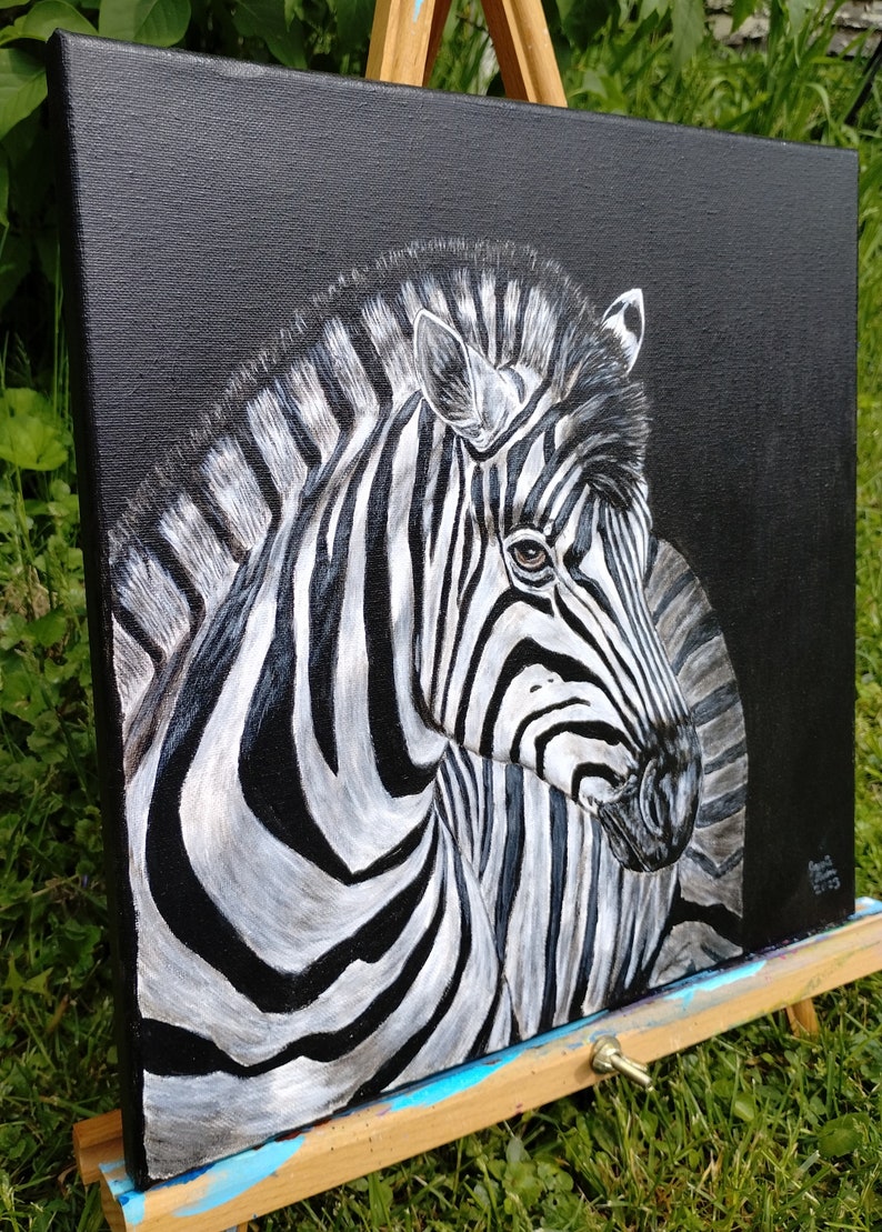 May include: A black and white zebra painting on a black canvas. The zebra's head is turned to the side, and its stripes are visible in detail.