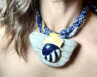 Wearable art piece, Wooden necklace with vintage ceramic and yellow shells on braided up-cycled fabric. With matching fabric knuckle ring.