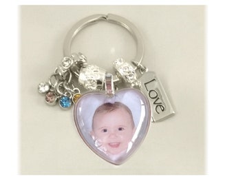 Custom photo keychain personalized with your picture.  Set in a beautiful 1" heart metal charm- with your choice of charms