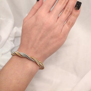 Guitar string bracelet made with six twisted 3 gold & 3 silver stainless steel repurposed guitar strings.