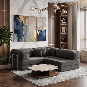 May include: A modern living room featuring a dark gray sectional sofa, a marble-topped coffee table, and abstract art with gold accents. The room has a hardwood floor and a patterned rug. Decorative lighting hangs from the ceiling.