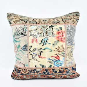 May include: A colorful patchwork pillow cover with a floral design. The pillow cover is made from a variety of fabrics and has a fringe border.